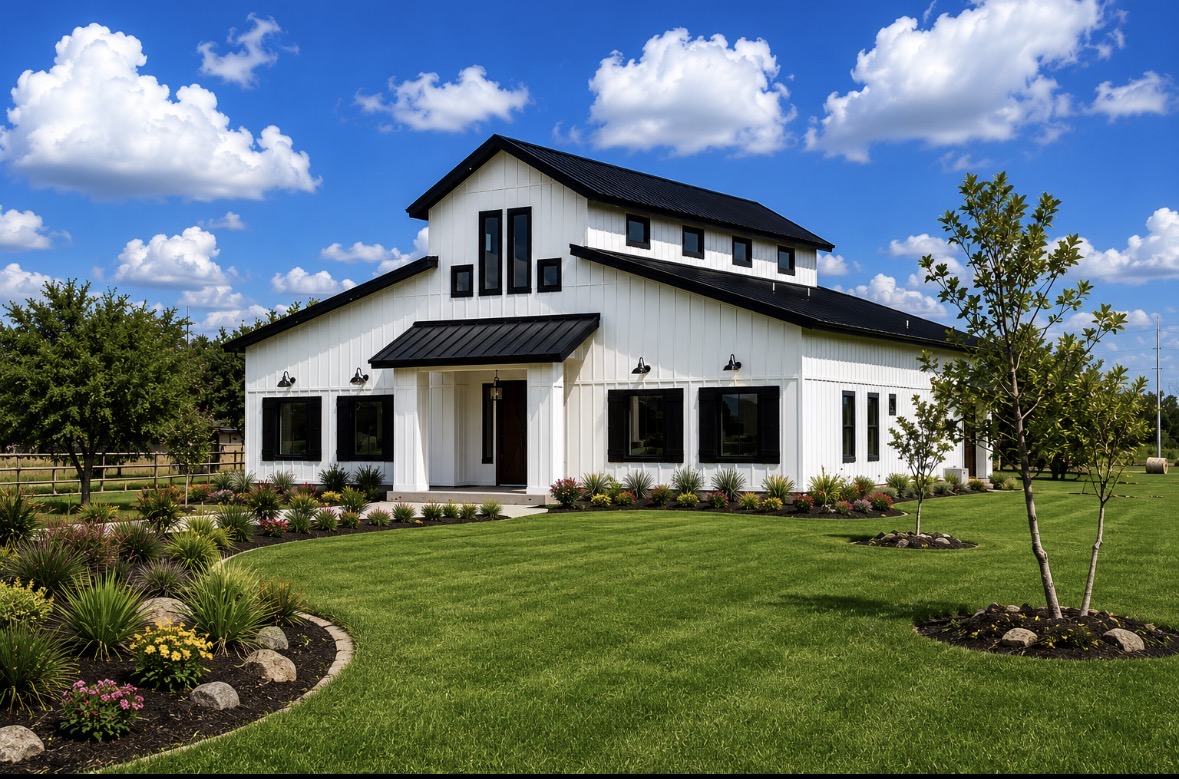 White modern farmhouse with black metal roof under a bright blue sky